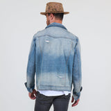 Person wearing a blue denim jacket and brown hat on a white background