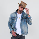 Man wearing a denim jacket, white shirt, gray jeans on a white background