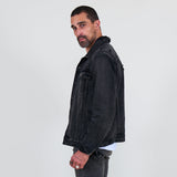 Man wearing a black denim jacket, gray jeans on a white background