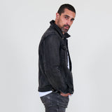 Man wearing a dark jacket, gray jeans on a white background