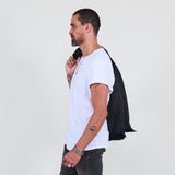 Man wearing a white t-shirt, dark jacket, gray jeans on a white background