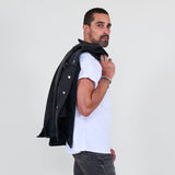 Man wearing a black jacket, white shirt, gray jeans on a white background