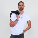 Man wearing a white t-shirt, dark jeans against a plain background
