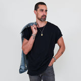 Man wearing a black t-shirt, gray jeans on a white background