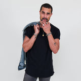 Man wearing a black t-shirt, gray jeans on a white background