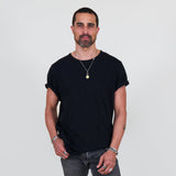Man wearing a black t-shirt, gray jeans on a white background
