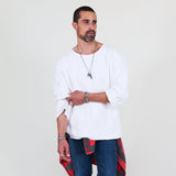 Man wearing a white sweater and blue jeans on a white background