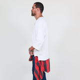 Man wearing a white sweater and blue jeans on a white background