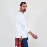 Man wearing a white sweater and blue jeans on a white background