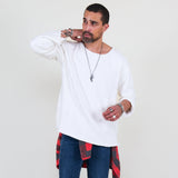 Man wearing a white sweater and blue jeans on a white background