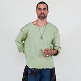 Person wearing a light green shirt and blue pants on a white background