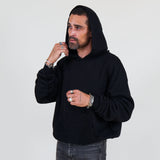 Person wearing a black hoodie and against a white background