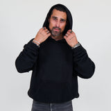 Person wearing a black hoodie and against a white background