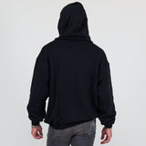 Person wearing a black hoodie and against a white background