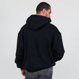 Person wearing a black hoodie and against a white background