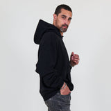 Person wearing a black hoodie and against a white background