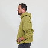 Person wearing a green hoodie and against a white background