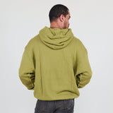 Person wearing a green hoodie and against a white background