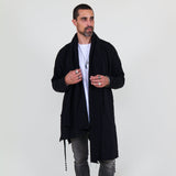 Man wearing a black shawl, white shirt, gray pants on a white background