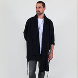 Man wearing a black shawl, white shirt, gray pants on a white background