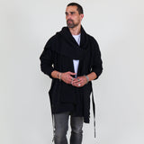 Man wearing a black shawl, white shirt, gray pants on a white background