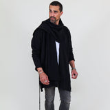 Man wearing a black shawl, white shirt, gray pants on a white background