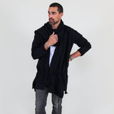 Man wearing a black shawl, white shirt, gray pants on a white background