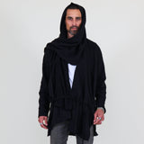 Man wearing a black shawl, white shirt, gray pants on a white background