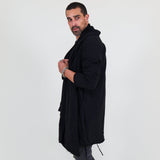 Man wearing a black shawl, white shirt, gray pants on a white background