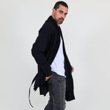 Man wearing a black shawl, white shirt, gray pants on a white background