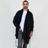 Man wearing a black shawl, white shirt, gray pants on a white background