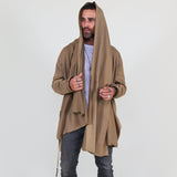 Man wearing a beige shawl, white shirt, gray pants on a white background