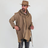 Man wearing a beige shawl, white shirt, gray pants on a white background