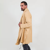 Man wearing a beige shawl, white shirt, gray pants on a white background