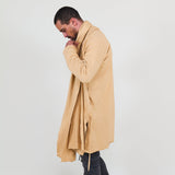 Man wearing a beige shawl, white shirt, gray pants on a white background