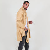 Man wearing a beige shawl, white shirt, gray pants on a white background