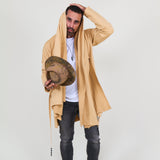 Man wearing a beige shawl, white shirt, gray pants on a white background