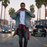 Man walking in denim jacket on a city street 